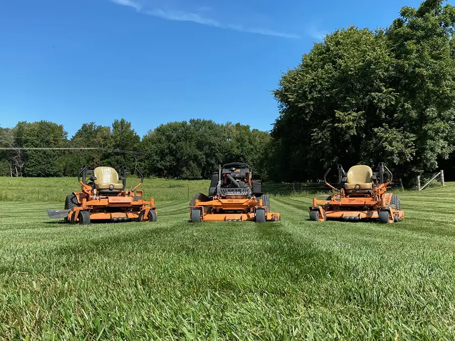 CanAm Professional Landscaping - lawn maintenance, lawn care - 3 riding mowers on well manicured lawn - Girard, IL