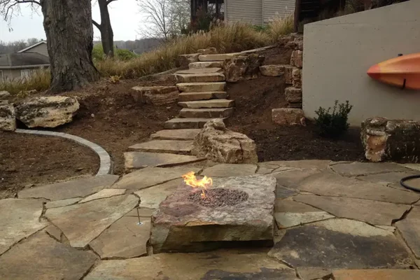 CanAm Professional Landscaping - landscaping project for backyard with flagstone steps, patio and fire pit - Girard, IL