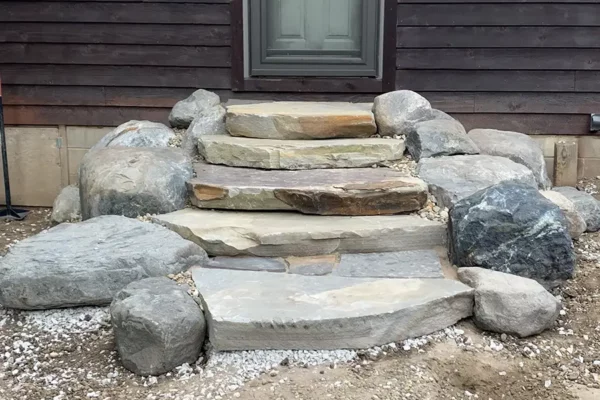 CanAm Professional Landscaping - rock stairs, steps leading out of house and into backyard - Girard, IL